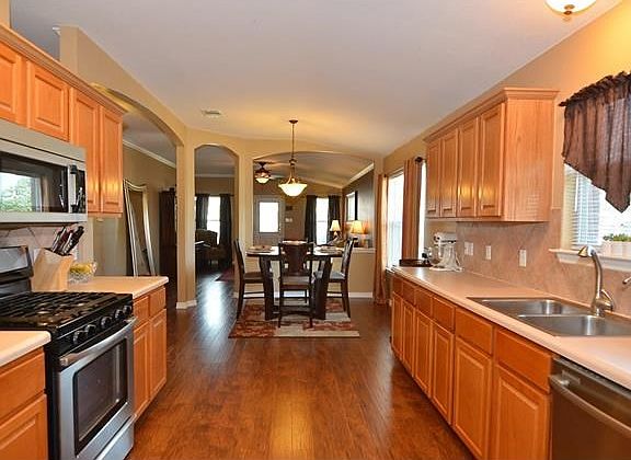 From the spacious kitchen, you have a great view of your living area. Take a look at the beautiful, durable laminate flooring. This flooring was replaced in 2012.