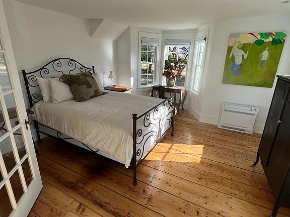 Private 1st floor ensuite primary bedroom with sitting room and full bath.