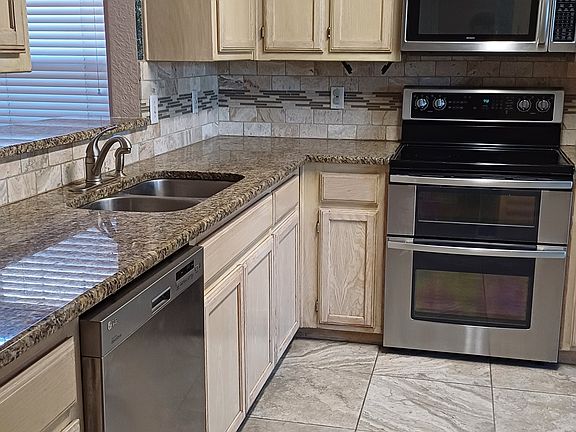 Renovated kitchen with granite counter tops and stainless steel appliances
