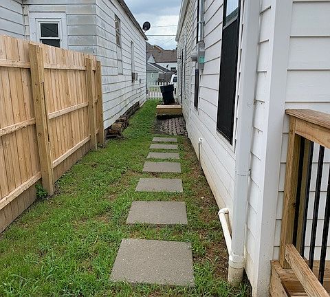 Side of the house with stepping stones to guest side door entry.