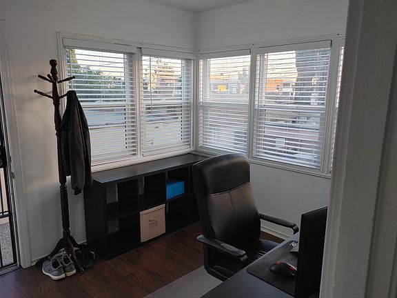 Bonus room at the front of the apartment with a wall of windows. Perfect for an office or sun room.