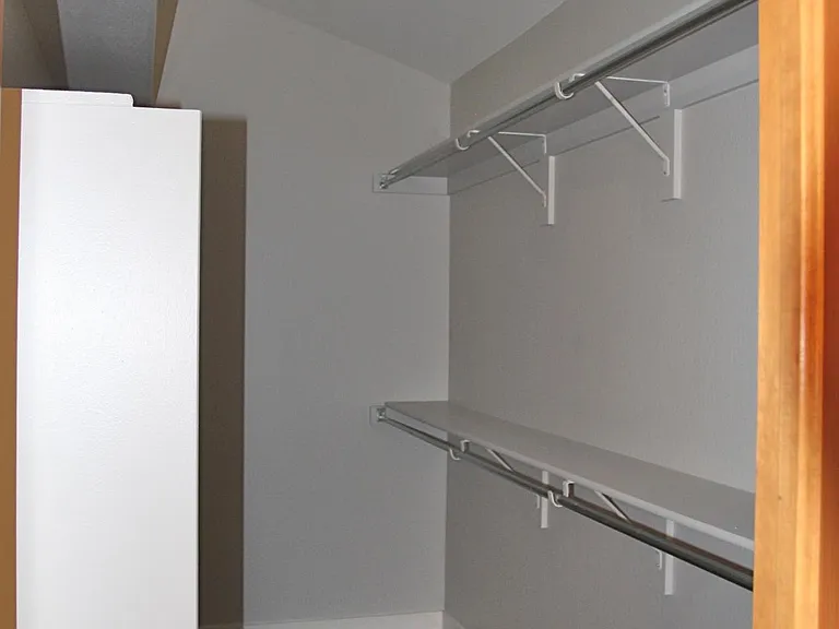 Large walk in closet measuring 12' by 5'4"