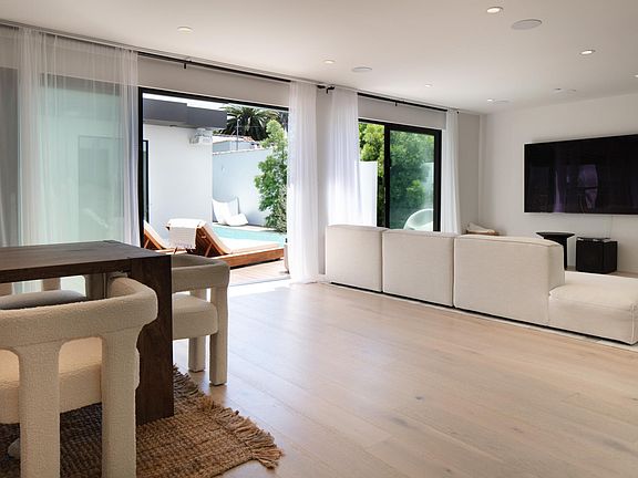 Living dining area pool view, 85" flat screen