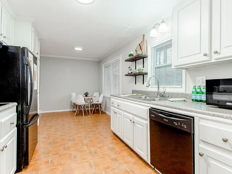 Open, spacious kitchen with two fridges, microwave, dishwasher, cooktop and oven.