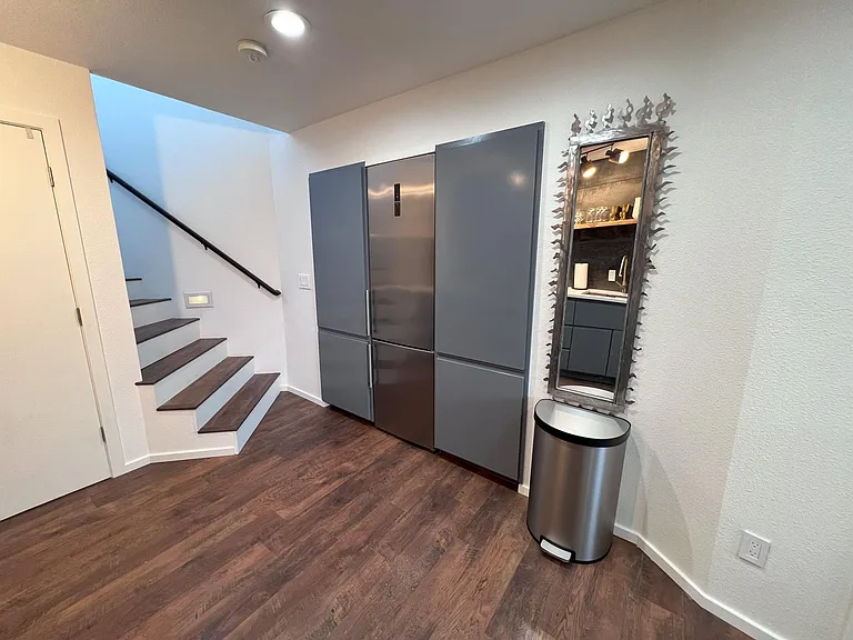 Fridge and microwave located across the counter
