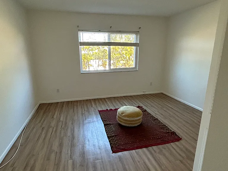 Spacious master bedroom with hurricane window
