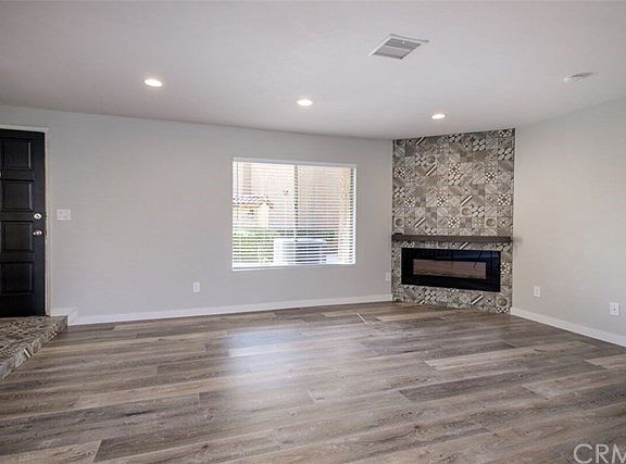 Front entry door that opens up to spacious living room and staircase.