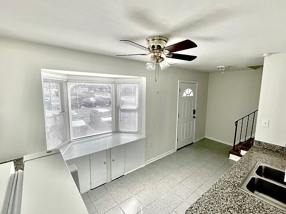 Main entrance (view of front door and bay window from inside the kitchen)