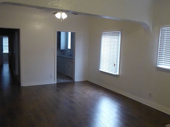 Great Room with view to kitchen and hallway leading to service porch, bedroom, and bathroom - each unit varies slightly
