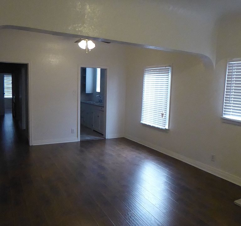 Great Room with view to kitchen and hallway leading to service porch, bedroom, and bathroom - each unit varies slightly