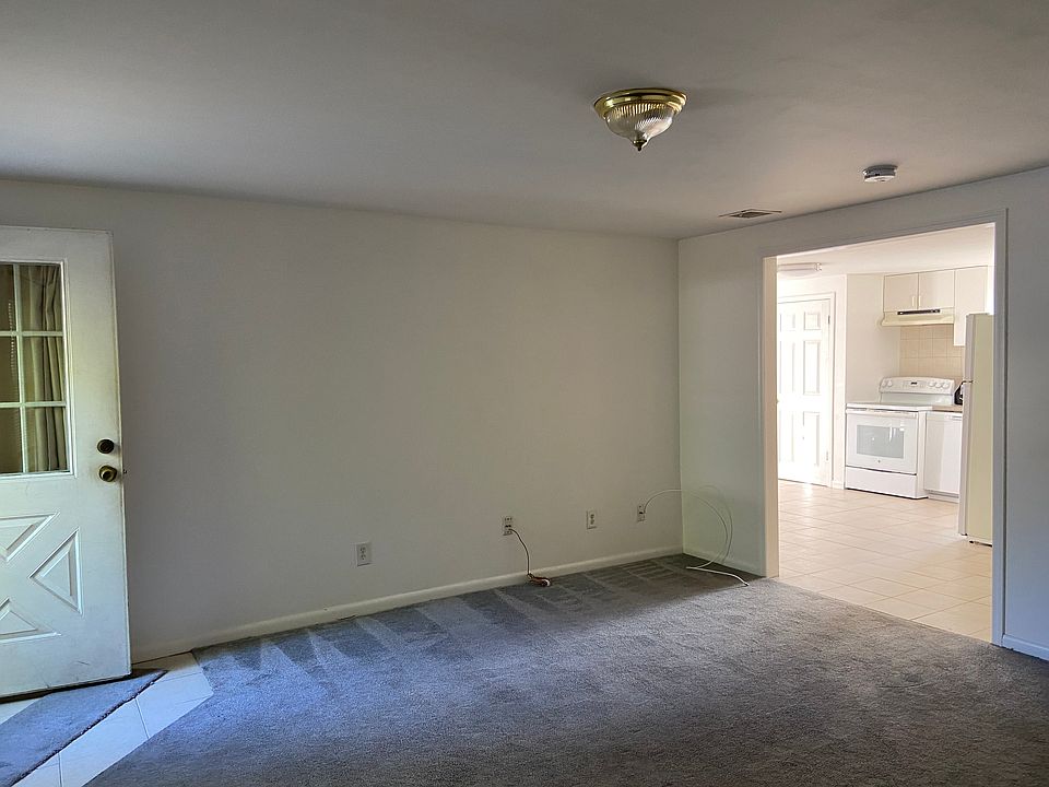 Lining room with from front door with kitchen in view