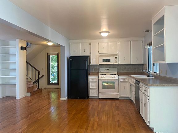 Open kitchen with white cabinets.