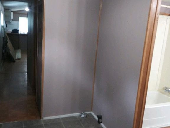 Hallway entrance to bathroom.. Dryer hook up..