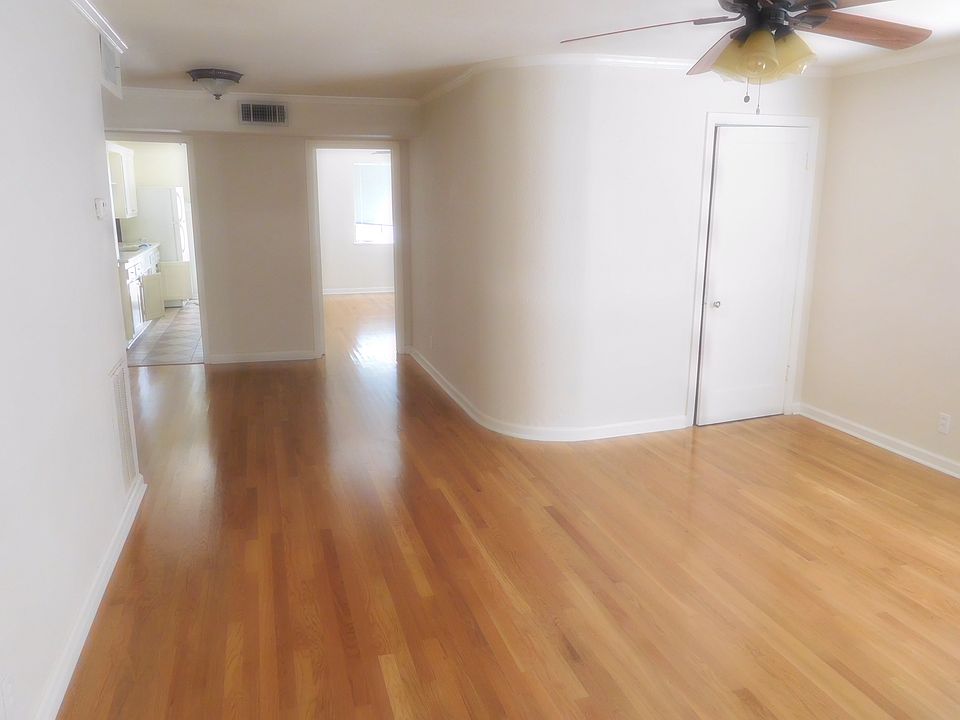 Living room looking toward kitchen (left) and bedroom (right).