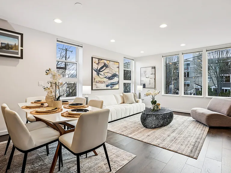 Sun-filled space for lounging and dining with hardwood floors.
