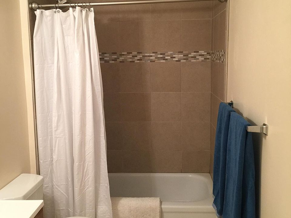 Newly tiled tub surround, new bath & sink faucets. Exhaust fan. Ample lighting with dimmer. Porcelain wall and floor tiles with mosaic trim in bath. Double towel rod.