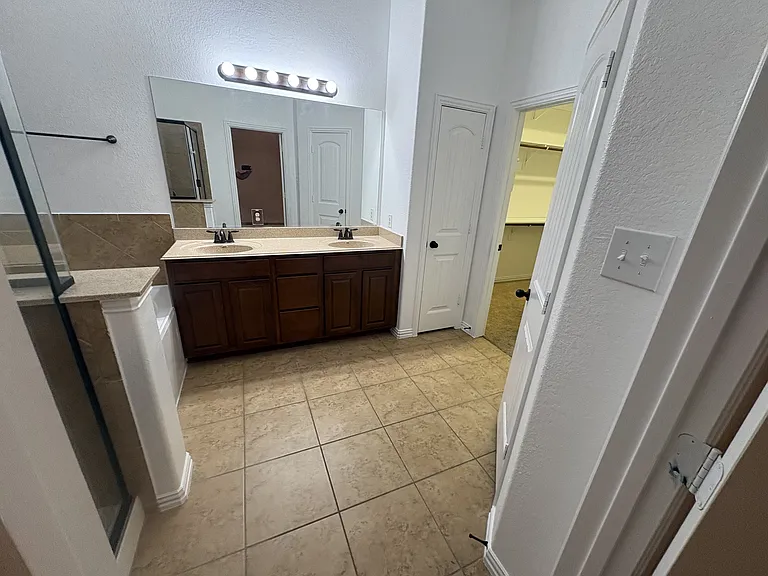 Primary Bathroom features dual sinks, soaking tub, shower, private water closet and a HUGE closet