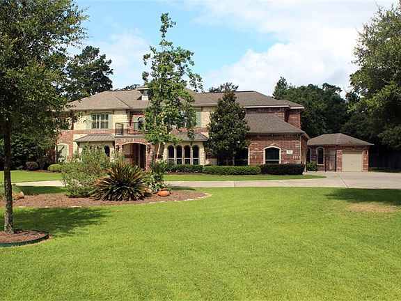 Built by David Powers, this beautiful brick and stone home sits on almost an acre and has a circular