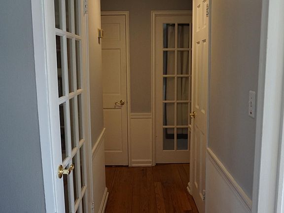 Hallway to Main Floor Bedrooms & Bathroom; door to basement