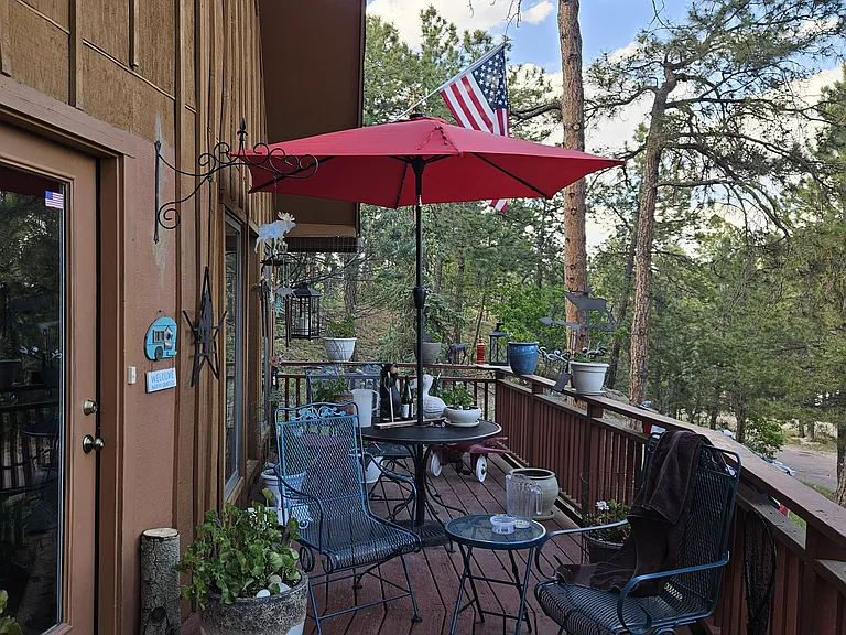 Second floor deck wraps around house.