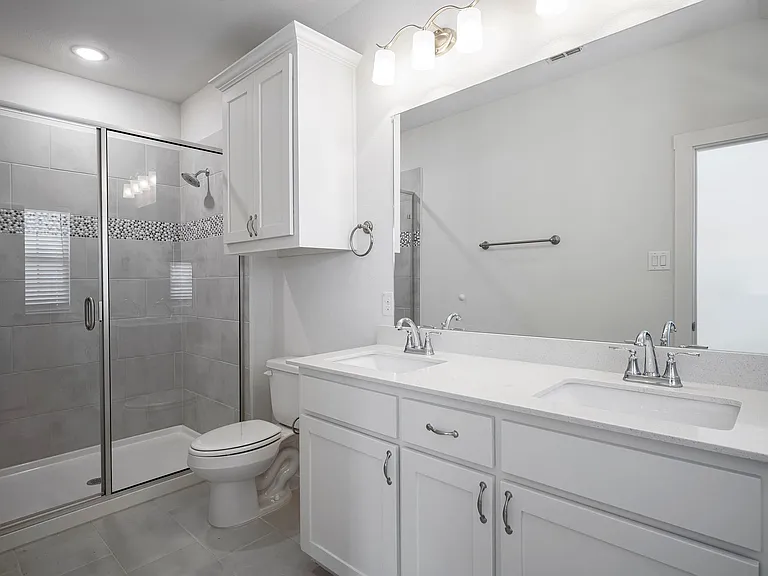 The primary suite has an en-suite bath with dual sinks, oversized shower, plus a large walk in closet.