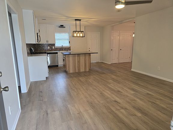 Entry front door view. With new waterproof plank flooring and ceiling fans. Entire interior of house newly painted.