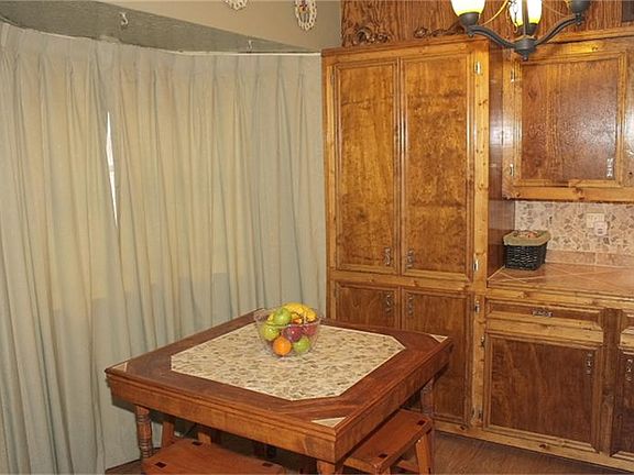 Kitchen dining area features bay window and lots of storage