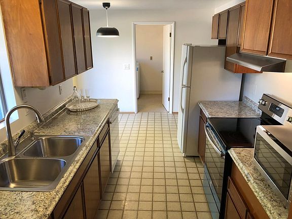 Updated kitchen with new counter, sink, stove, range hood, a