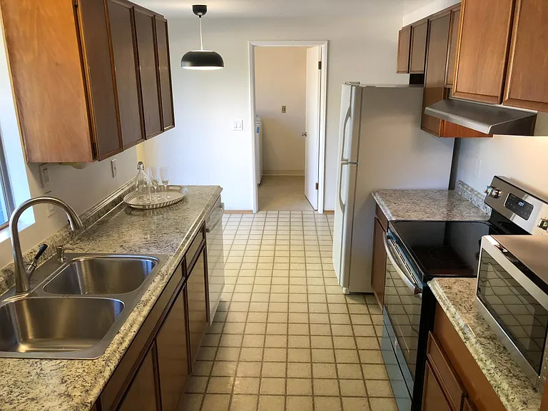 Updated kitchen with new counter, sink, stove, range hood, a