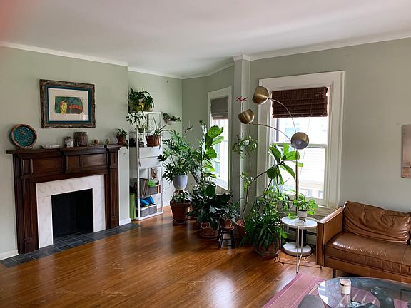 21x18-sq ft living room with decorative fireplace, high ceilings, polished hardwood floor, 4 large windows