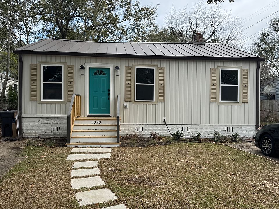 Front porch added along with new siding, windows, lighting, sidewalk and 2 car parking pad.