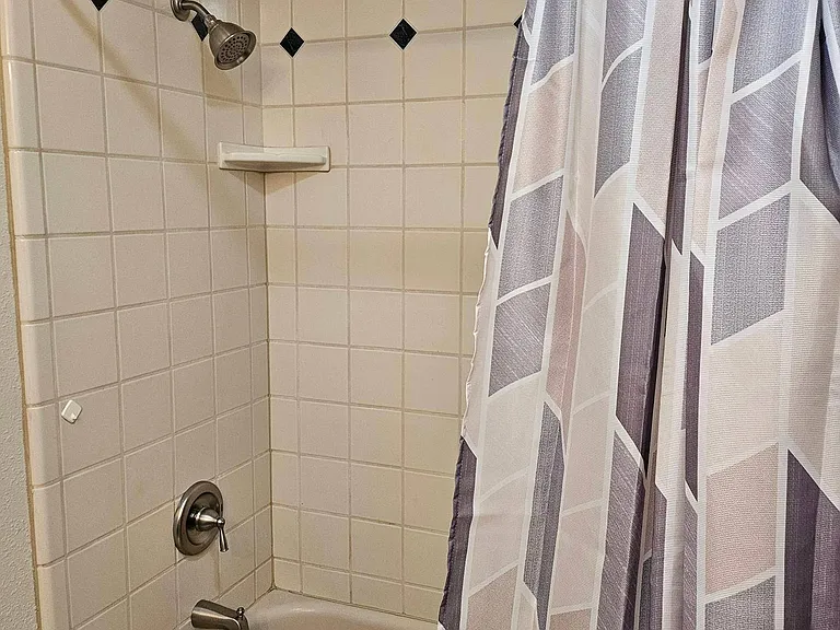 Full bathtub with shower