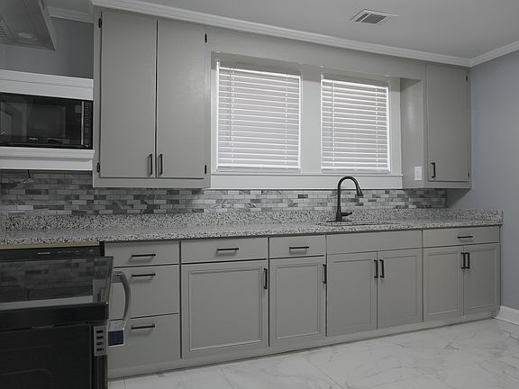 granite counter, microwave, dishwasher, new cabinets, matching back splach, black/stainless steel sink