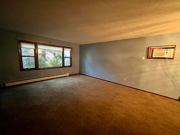 Living room with built in air conditioner.