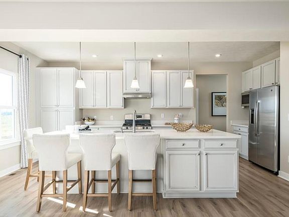 Open Kitchen with White Cabinets and Granite Counter Top Stainless Steel Appliances
