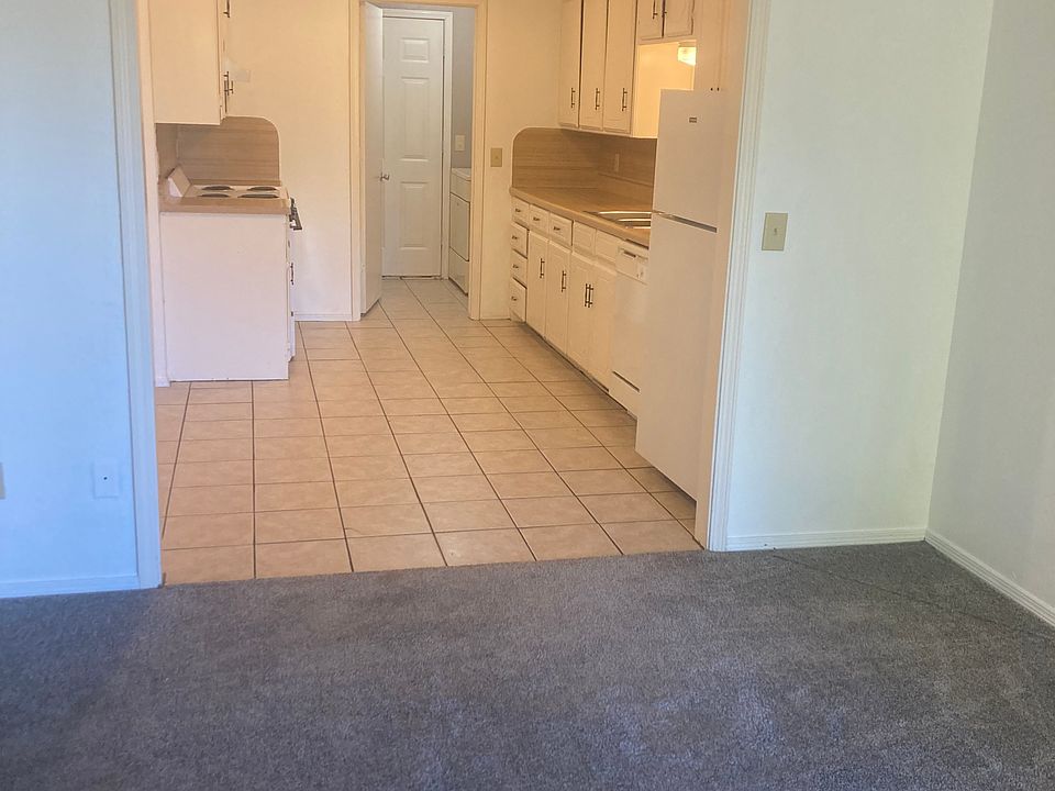 Eat-in kitchen with top/bottom refrigerator. Utility room with side by side full size washer/dryer.
