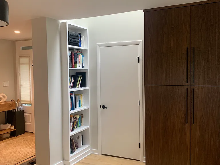 Extra storage custom cabinet, book shelf, skylight, and door the large mud room and laundry room with sink and custom storage. Perfect for busy families