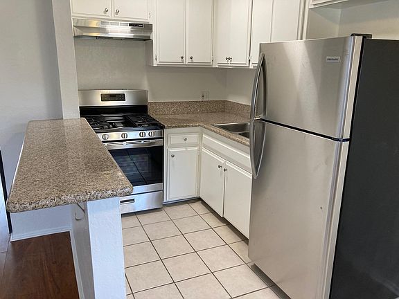 Brand new stainless steel stove, oven, hood vent and refrigerator