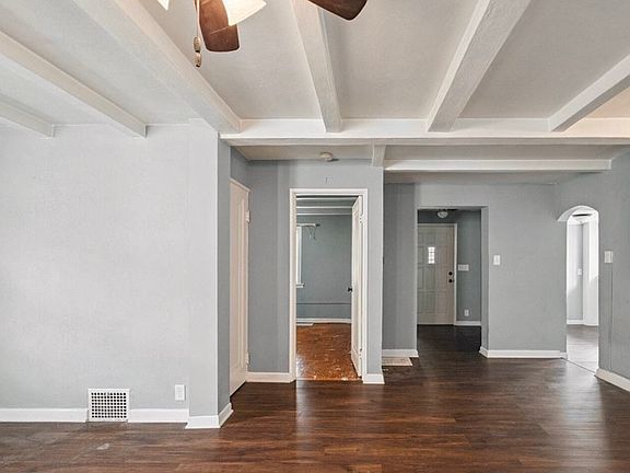 Downstairs bedroom, front door, entrance to kitchen.
