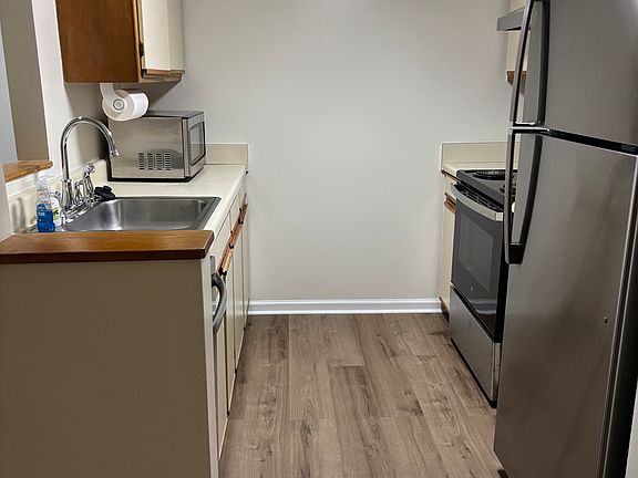 Kitchen with new refrigerator, oven/stove, and dishwasher
