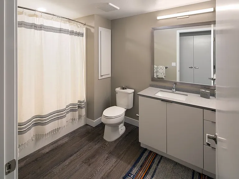 Bath with quartz countertop and hard surface flooring