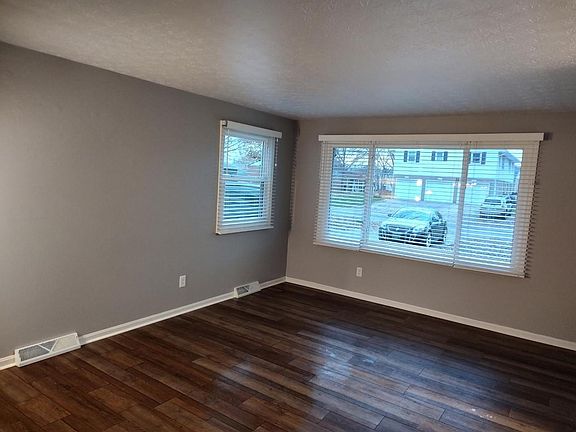 Livingroom with beautiful flooring and lots of light through the windows