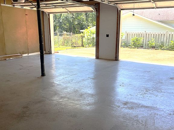 BIG GARAGE LEADS INTO DOWNSTAIRS DEN & LAUNDRY ROOM & HALF BATH.