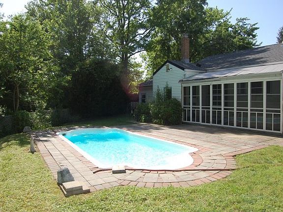 Screened porch over looking private yard and pool.