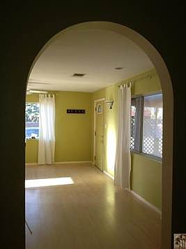 A view into the living room. Check out the arched doorway.