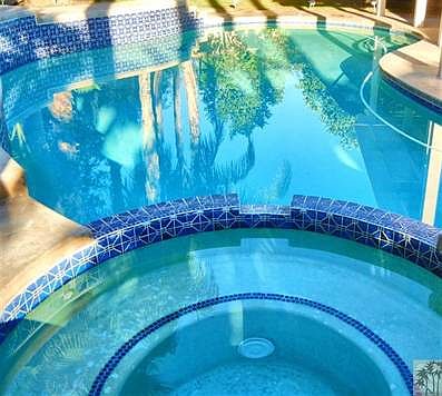 Spa waterfalls into pool.
