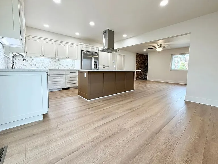Kitchen area from sliding glass doors to screened in back deck area.