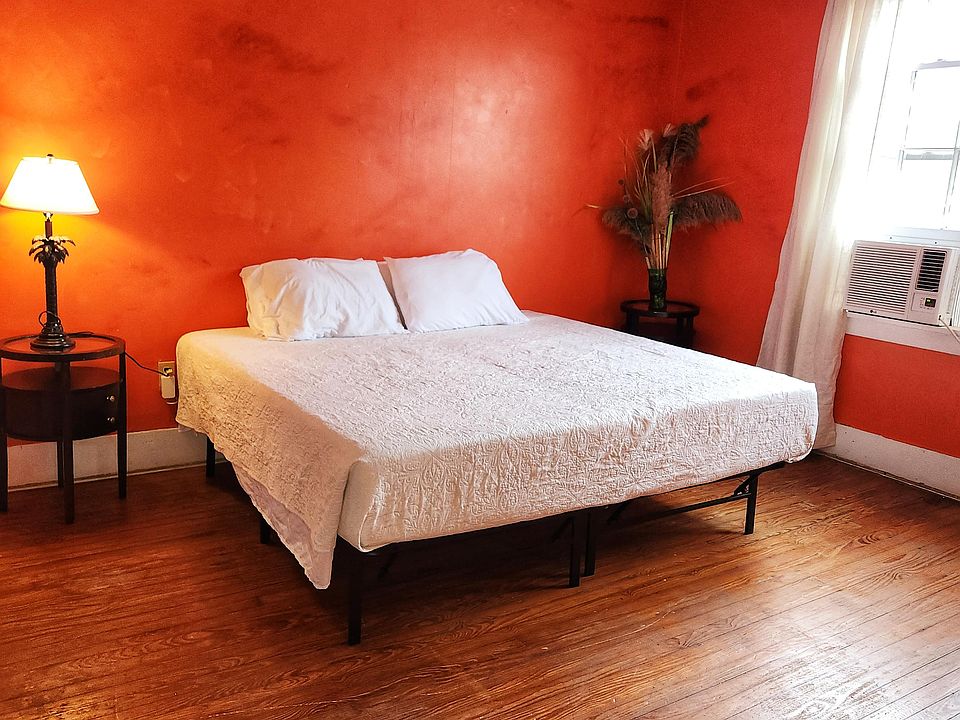 2nd Floor Orange Side yard view, 2 windows, King bed, dresser, wood floor, window AC/Heat unit, dedicated work station, NO TV