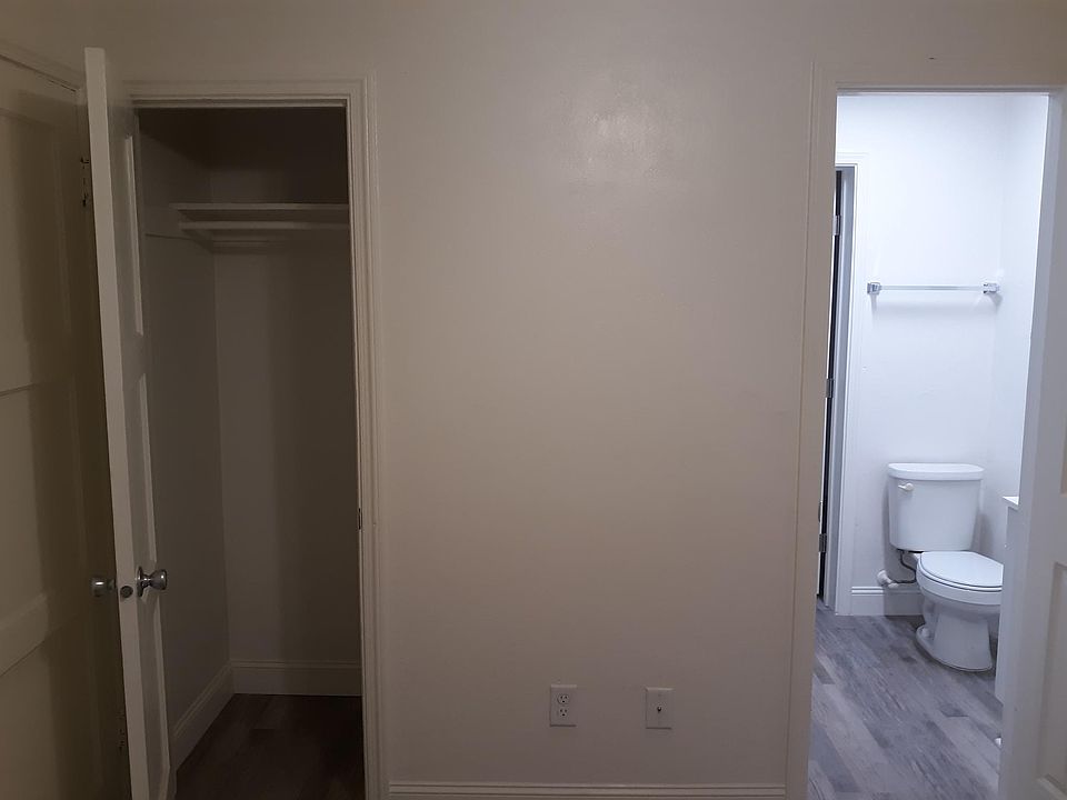 Bedroom 1 closet with view to bathroom