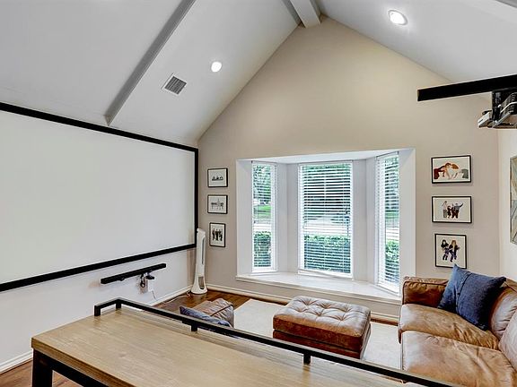 Beautiful room with French doors, tall beamed ceiling, and bay window! Current owner was using as a media room "man cave", it would also make a wonderful study.